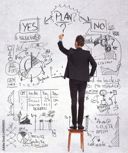 Photo: business man standing on a chair drawing business man standing on a chair drawing
