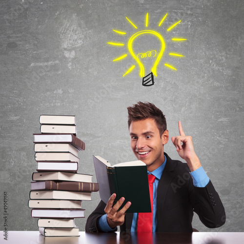 Photo: business man having a great idea while reading business man having a great idea while reading
