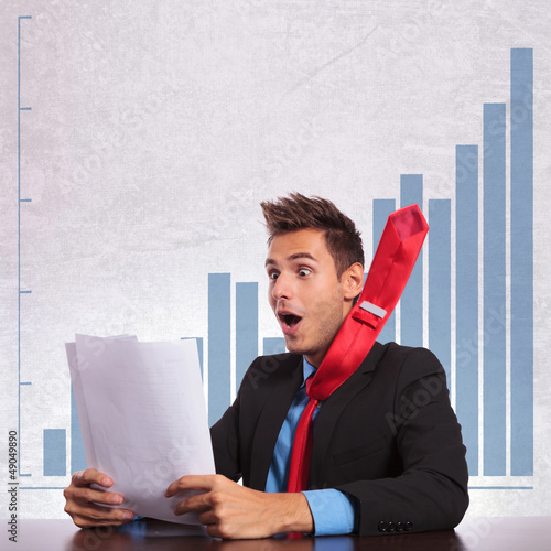 Photo: business man with flying tie reading the good news business man with flying tie reading the good news