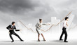 Three business people pulling rope