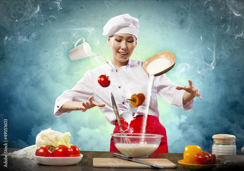 Photo: Asian female cooking with magic Asian female cooking with magic