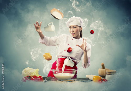 Photo: Asian female cooking with magic Asian female cooking with magic