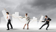 Three business people pulling rope