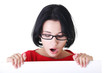 Shocked woman holding blank board
