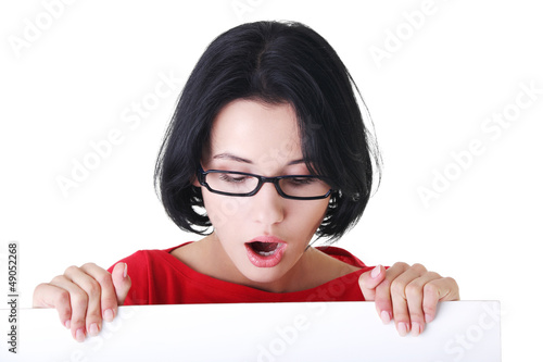 Photo: Shocked woman holding blank board Shocked woman holding blank board