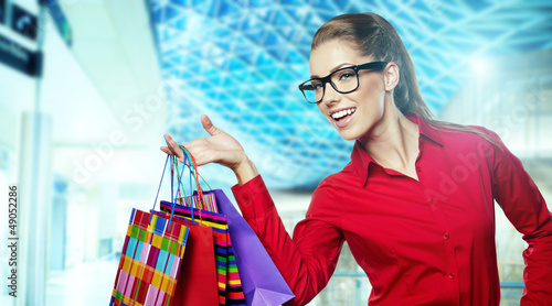 Photo: Beautiful shopping woman at a mall smiling Beautiful shopping woman at a mall smiling