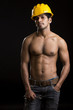 Foto: Healthy muscular young man with yellow helmet on black. Healthy muscular young man with yellow helmet on black.