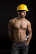 Foto: Healthy muscular young man with yellow helmet on black. Healthy muscular young man with yellow helmet on black.