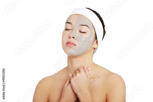 Photo: Beautiful woman with clay facial mask Beautiful woman with clay facial mask