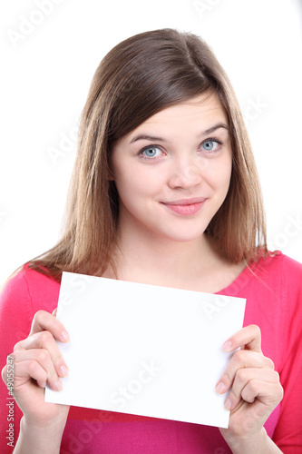 Photo: Excited young female showing empty blank paper Excited young female showing empty blank paper