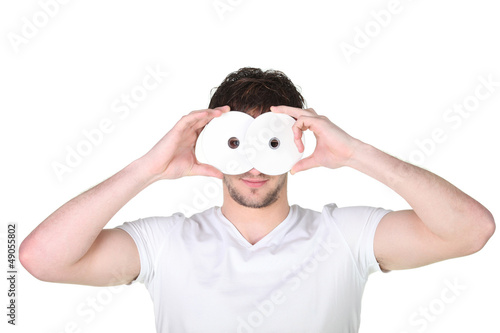 Photo: young man hiding his face behind a mask young man hiding his face behind a mask