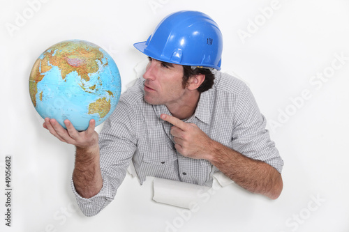Photo: Builder angrily pointing at globe Builder angrily pointing at globe
