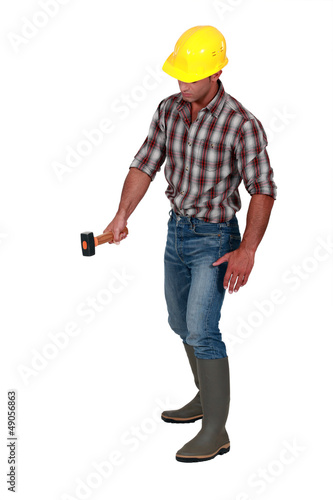 Photo: Worker holding hammer Worker holding hammer