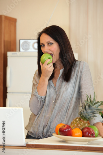 Photo: Woman eating an apple Woman eating an apple