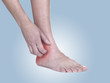 Women scratch itchy ankle with hand.