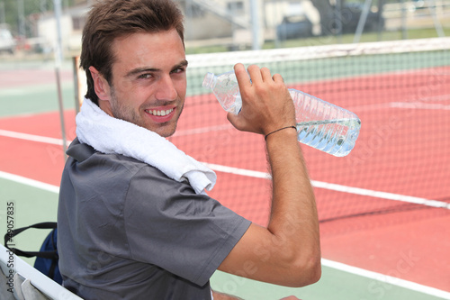 Photo: Tennis player drinking water Tennis player drinking water