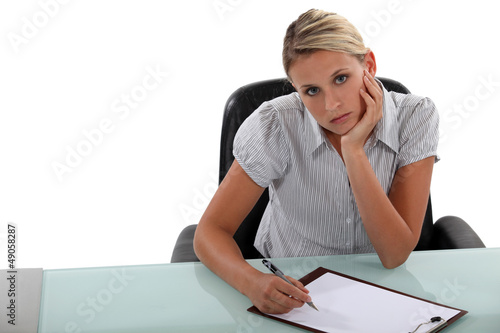 Photo: Bored woman taking notes Bored woman taking notes