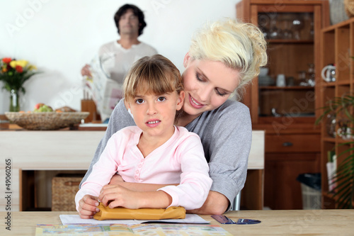 Photo: Mother helping daughter with homework Mother helping daughter with homework