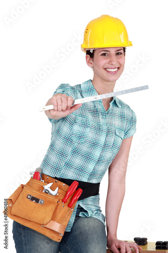 Photo: Tradeswomanwith a ruler Tradeswomanwith a ruler
