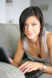 Photo: woman relaxing at home with her laptop woman relaxing at home with her laptop