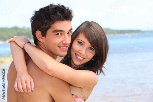 Photo: Teens embracing on the beach Teens embracing on the beach