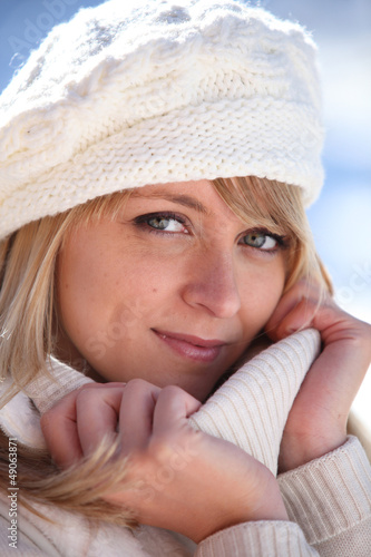 Photo: Blonde woman in a cream jumper and hat Blonde woman in a cream jumper and hat