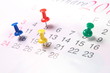 Closeup calendar page with drawing-pins