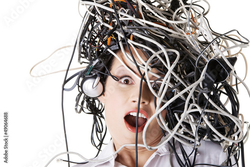 Photo: Shocked businesswoman with cables on head Shocked businesswoman with cables on head