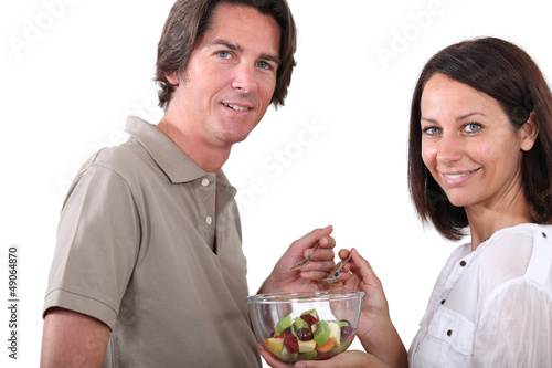 Photo: Couple eating fruit salad Couple eating fruit salad