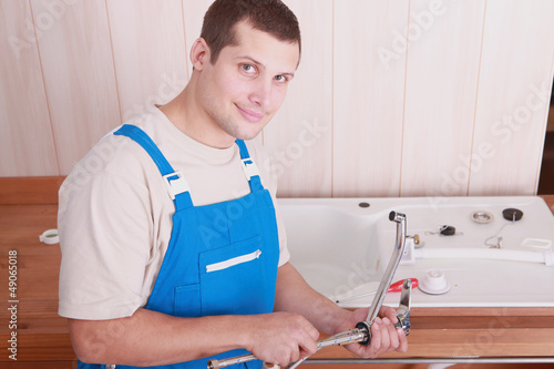 Photo: Plumber installing a kitchen sink Plumber installing a kitchen sink