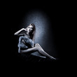 A young and sexy woman posing in erotic lingerie and fur