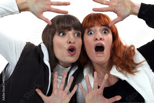 Photo: Women with their faces pressed against glass Women with their faces pressed against glass