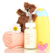Photo: Bottle of milk, pacifier and baby cosmetic with towel isolated Bottle of milk, pacifier and baby cosmetic with towel isolated
