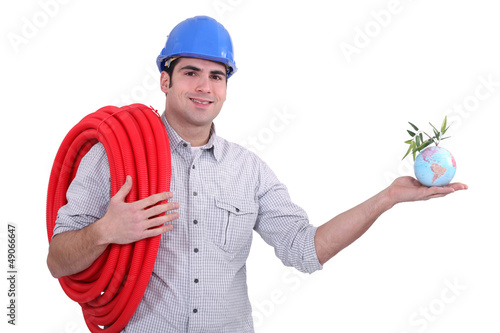 Photo: Plumber holding miniature globe Plumber holding miniature globe
