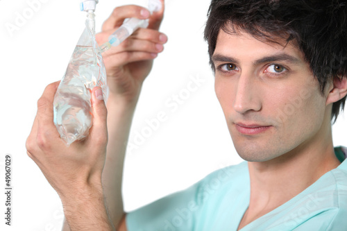 Photo: Nurse preparing drip. Nurse preparing drip.
