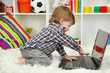cute little boy and notebook in room