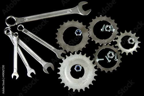 Photo: Machine gear, metal cogwheels, nuts and bolts isolated on black Machine gear, metal cogwheels, nuts and bolts isolated on black