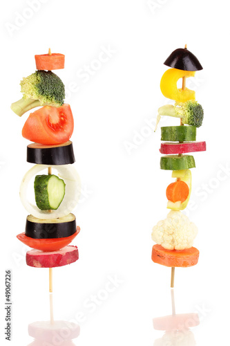 Photo: Sliced vegetables on wooden pick isolated on white Sliced vegetables on wooden pick isolated on white