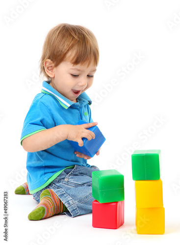 Photo: cute little boy with toy color cubes, isolated on white cute little boy with toy color cubes, isolated on white