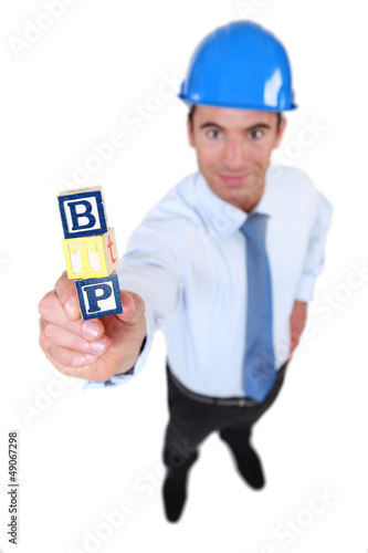 Photo: Architect holding building blocks Architect holding building blocks