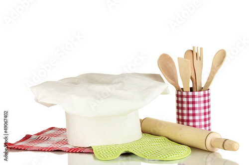 Photo: Chef's hat with spoons and battledore isolated on white Chef's hat with spoons and battledore isolated on white