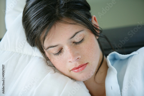 Photo: Young woman resting on a sofa Young woman resting on a sofa