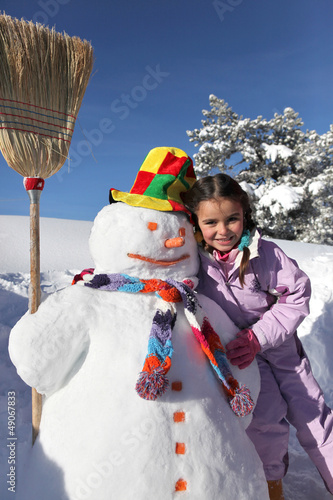 Photo: Little girl with snowman Little girl with snowman