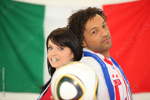 Photo: Couple of Italian soccer fans stood back to back Couple of Italian soccer fans stood back to back
