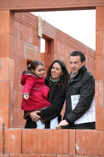 Photo: Family on the building site of their new home Family on the building site of their new home