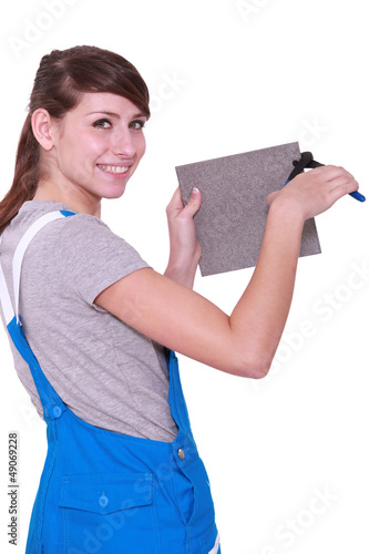 Photo: Woman cutting tile Woman cutting tile