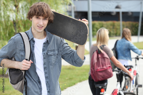 Photo: Student on campus with a skateboard Student on campus with a skateboard