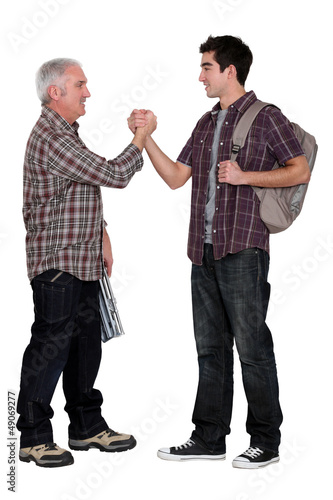 Photo: Senior man and young man handshaking Senior man and young man handshaking