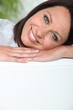 Woman resting head on sofa