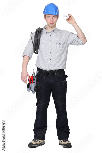 Photo: Electrician holding cable and electrical socket Electrician holding cable and electrical socket